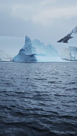 Big-Iceberg-Ice-Formation-in-Ocean-Sea-Water,-Large-Amazing-Shapes-Bizarre-Icebergs-in-Antarctica-Scenery-Vertical-Video-for-Social-Media,-Instagram-Reels-and-Tiktok,-Antarctic-Peninsula-Landscape