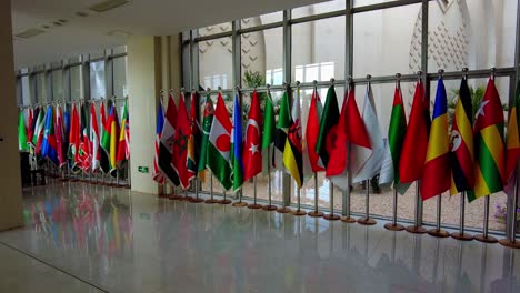 Several-international-flags-arranged-in-array-at-SDKJ-international-conference-center-hallway,-Banjul---Senegambia