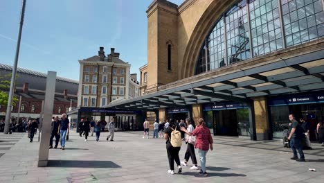 People-walking-in-front-of-King's-Cross-Station-on-a-sunny-day