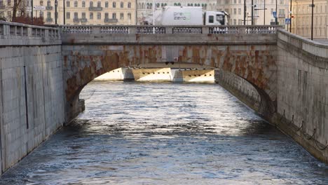 Old-stone-bridge-Norrbron-in-Stockholm,-Sweden-with-Grand-Hotel-visible-in-background