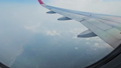 The-view-from-an-airplane-window-on-the-wing-and-a-working-airplane-engine