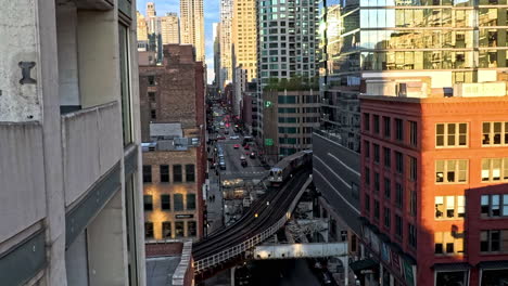 CTA-public-transport-train-moving-between-skyscrapers-in-sunny-downtown-Chicago