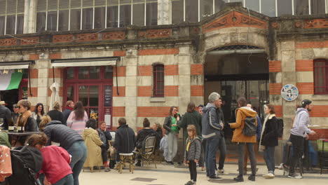 Shot-of-locals-crowding-at-an-old-historic-Central-market-in-La-Rochelle,-France-at-daytime