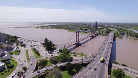 Aerial-View-of-Santa-Fe-City-Bridges-Colgante-Carretero-and-Traffic-Above-River,-Argentina