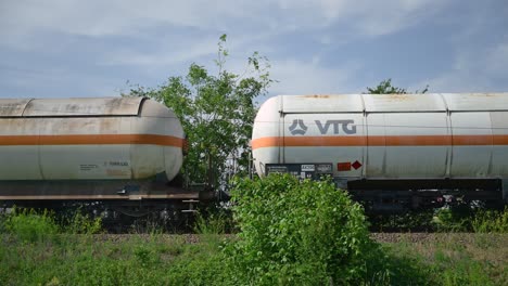 VTG-gas-rail-tank-car-in-train-composition-through-Vojvodina-countryside-landscape