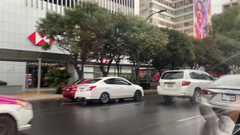 Pink-and-white-taxi-cars-in-Mexico-City-traffic,-inside-car-POV