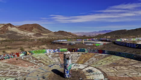 Drone-rising-in-front-of-the-Wheel-of-Misfortune,-in-sunny-Henderson,-NV-USA