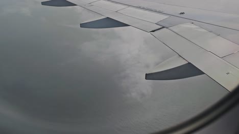 the-wings-of-the-plane-and-the-beautiful-view-from-the-glass-window-of-aircraft