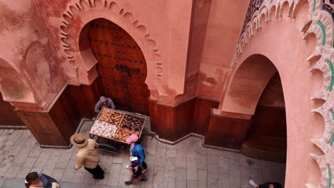 Narrow-busy-street-in-Morocco-city-Marrakesh,-vegetables-street-seller