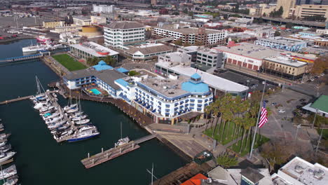 Oakland-CA-USA,-Drone-Shot-of-Jack-London-Square-Marina-and-Waterfront-Buildings