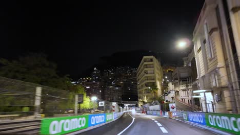 A-night-drive-through-Monte-Carlo-in-the-Principality-of-Monaco-with-street-circuit-racing-barriers-installed-in-preparation-for-the-Monaco-Grand-Prix-at-the-historic-famous-circuit