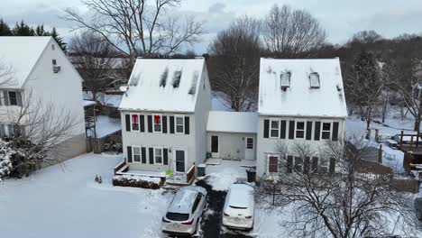 Aerial-approaching-shot-of-tonwhouses-with-decorated-windows-in-winter-season