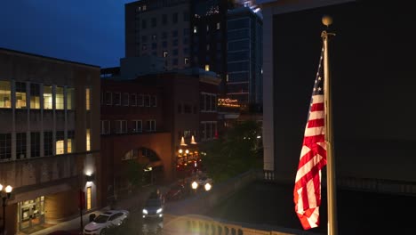 Aerial-view-of-american-flag-in-american-town-at-night