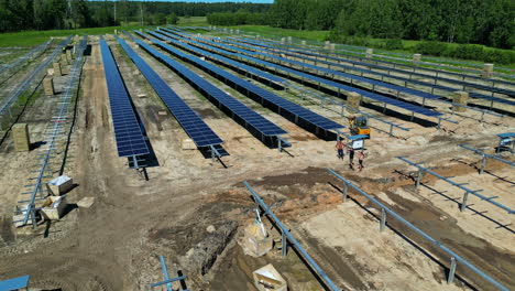 Solar-panel-array-green-energy-park-under-construction,-electricity-from-sun