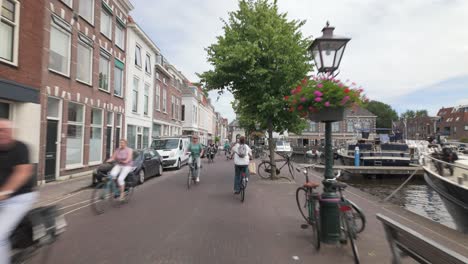 People-Riding-Bicycle-In-The-Streets-Of-City-Gate-Zijlpoort-In-Leiden,-Holland,-Netherlands