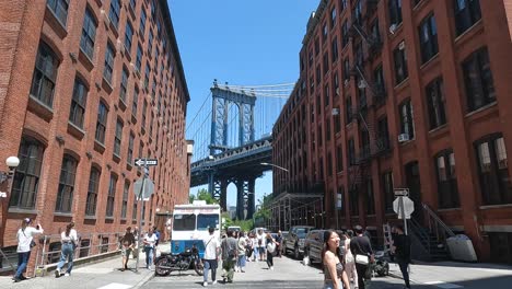 A-young-Asian-girl-posing-and-many-other-people-walking-on-the-alley-in-front-of-the-Golden-Bridge