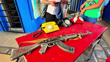 Old-rotary-phones-and-an-antique-rifle-on-a-red-table-at-Ventspils-International-Radio-Astronomy-Center