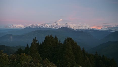 Mountains-and-Forest-Landscape-at-Sunset-in-Nepal,-Pink-Sunset-Sky-and-Beautiful-Himalayas-Mountains-Scenery-at-Poon-Hill-Viewpoint-on-Trek-while-Trekking-and-Hiking-in-Nepal,-Snowcapped-Mountain-Tops