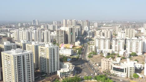 Drone-Camera-is-moving-backwards-with-lots-of-high-rise-buildings-around