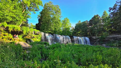 Static-shot-of-the-Keila-Waterfalls-in-Estonia-in-the-green-nature,-slow-motion-with-copy-space