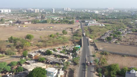 Phone-camera-moving-forward-showing-a-big-party-plot-and-lots-of-slum-area-around