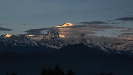 Sunrise-Himalayas-Mountains-Timelapse-in-Nepal,-Time-Lapse-of-Snowcapped-Mountain-Range-at-Sunrise-with-Clouds-Moving-in-Beautiful-Golden-Orange-Light,-Beautiful-Snow-Covered-Winter-Summits