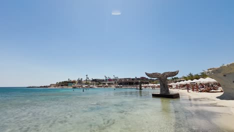 Blue-flag-beach-club-in-Izmir-Cesme-Alacati,-beach-umbrellas,-chairs,-beach-party