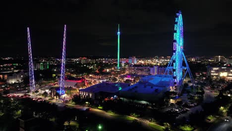 Illuminating-tower-and-Ferris-wheel-in-amusement-park-of-Orlando-city-at-night