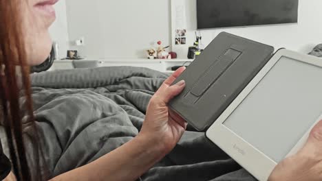 Woman-relaxing-at-apartment-home-reading-her-electronic-equipment,-slow-mo