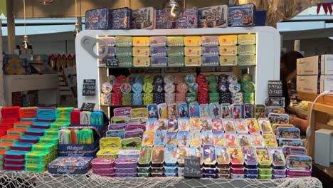 Array-of-colorful-canned-sardines-are-displayed-neatly-in-a-store-in-Mercado-do-Bolhão-in-Porto,-Portugal