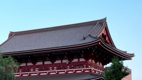 Traditional-Japanese-temple-with-intricate-roof-design-under-a-clear-blue-sky