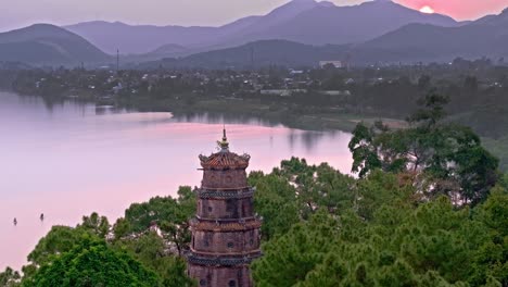 Serene-sunset-at-Hue,-Vietnam,-showcasing-the-beautiful-pagoda-overlooking-the-calm-waters-of-the-river