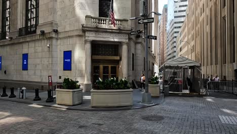 A-panning-4K-shot-a-woman-entering-the-New-York-Stock-Exchange-alone-but-two-businessmen-men-are-smoking-on-the-right-side-of-the-frame