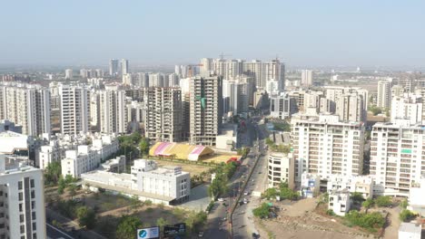 many-vehicles-driving-on-the-road-and-a-large-high-rise-building-is-visible-in-the-background