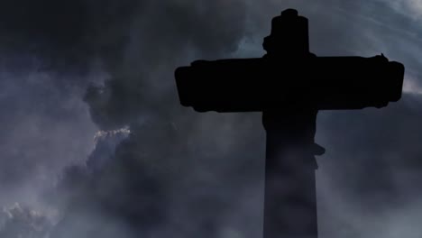 cross-silhouette-dark-clouds-background