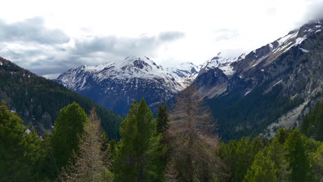 Drone-flying-over-Maloja-Pass-with-breathtaking-landscape-in-background,-Swiss-Alps