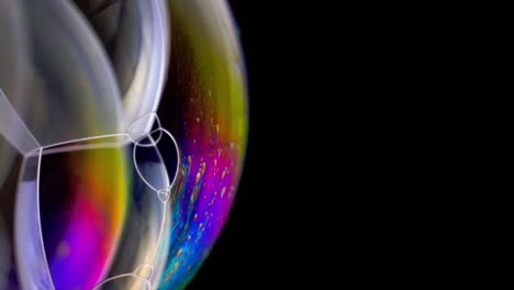 Close-up-image-of-colorful-soap-bubbles-against-a-black-background