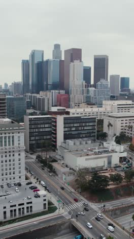 Downtown-Los-Angeles-USA,-Vertical-Aerial-View-of-Financial-District,-County-Courts-and-Administrative-Buildings,-US-101-Interstate-Highway-Traffic