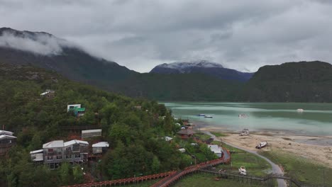 Aerial-View-of-Caleta-Tortel,-Coastal-Community-With-Elevated-Wooden-Pathway-Along-Coastline,-Chile