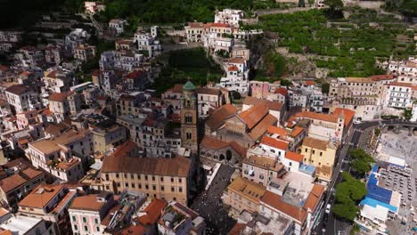 Drone-Flying-Away-from-Amalfi-Cathedral-on-Beautiful-Day-in-Amalfi-Coast,-Italy