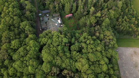 Pullback-Reveal-Of-Water-Tower-Surrounded-By-Lush-Green-Trees-In-Essex,-UK