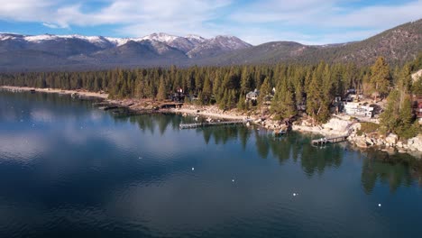 Lake-Tahoe-USA-on-Sunny-Winter-Day,-Scenic-Lakefront-With-Pine-Forest-and-Docks,-Drone-Aerial-View