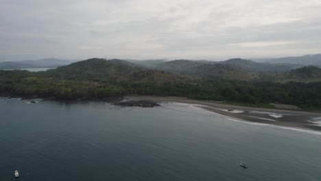 The-serene-coastline-of-santa-catalina,-panama,-with-lush-hills-and-calm-waters,-aerial-view