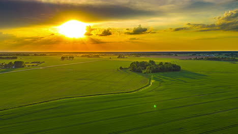 Motion-time-lapse,-drone-flying-over-countryside-fields,-sunny-summer-evening