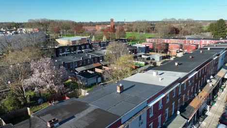 Aerial-rising-shot-of-colorful-row-of-houses-in-suburb-district-of-american-town