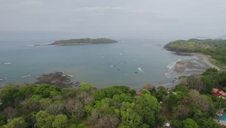 Santa-catalina-beach-and-lush-greenery-with-boats-in-the-calm-sea,-aerial-view