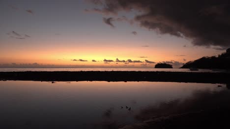 Man-Taking-Photos-in-Scenic-Reflection-Sunset-in-St-Vincent-Coast