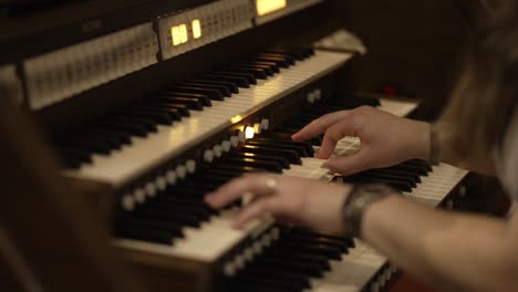 Close-up-of-hands-playing-an-organ-keyboard,-focusing-on-the-musical-performance