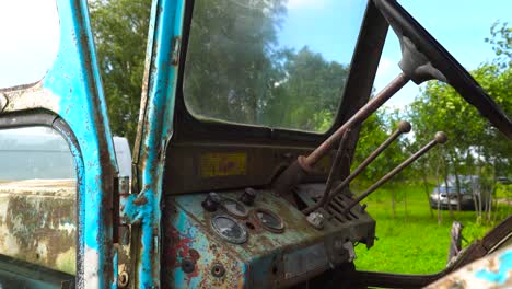 Old-soviet-tractor-cab-with-steering-wheel-and-indicator-panel,-Latvia