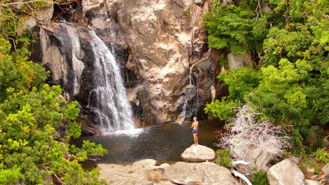 Man-Jumping-Off-A-Rock-And-Plunging-Into-A-Majestic-Waterfall-Pool-In-Nui-Chua-National-Park,-Vinh-Hy-Bay,-Vietnam